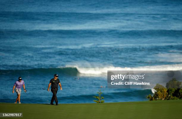 Patrick Reed of the United States and caddie Kessler Karain walk the 11th green during the Pro-Am prior to the Sentry Tournament of Champions at the...