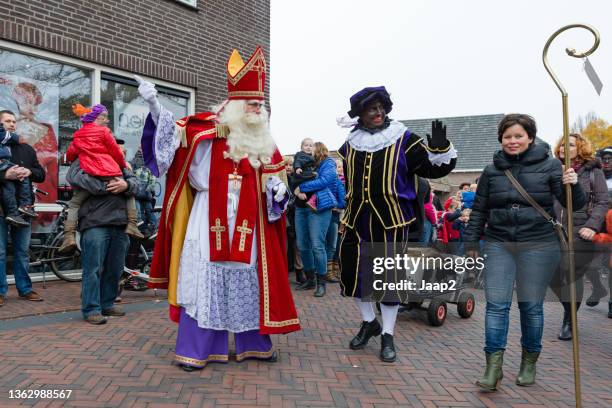 arrival parade of 'sinterklaas' and his 'zwarte pieten' in wierden - zwarte piet stock pictures, royalty-free photos & images