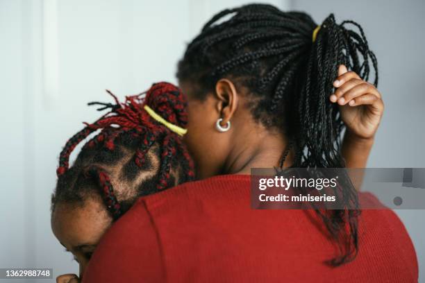 unrecognizable mother embracing her daughter in bedroom - unrecognisable person stock pictures, royalty-free photos & images