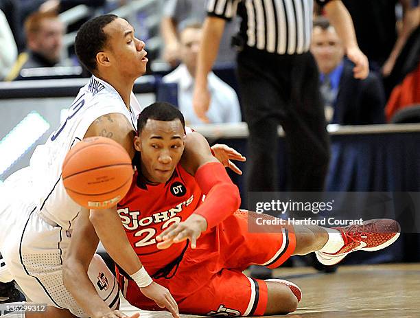 Connecticut's Shabazz Napier, left, battles for the ball with St. John"s Amir Garrett at the XL Center in Hartford, Connecticut, Saturday, December...