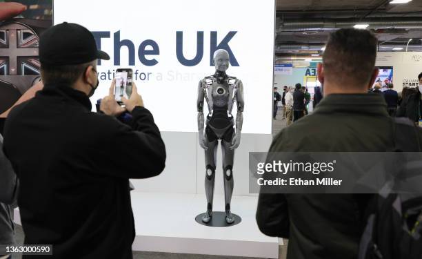 Attendees look at an Ameca model humanoid robot by British company Engineered Arts at CES 2022 at The Venetian Las Vegas on January 5, 2022 in Las...