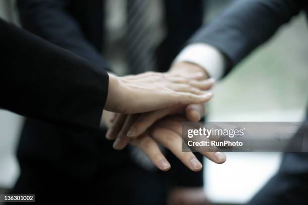 businessmen stacking hands - nur japaner stock-fotos und bilder