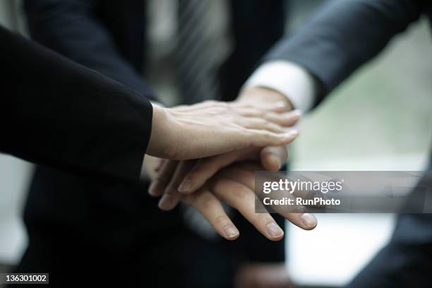 businessmen stacking hands - hand stack stock pictures, royalty-free photos & images