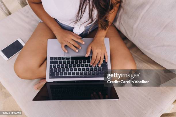 high angle view of a unrecognizable woman using the computer, working from the beach - todos santos mexico fotografías e imágenes de stock