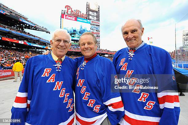 New York Rangers alumni Ed Giacomin, Rod Gilbert and Harry Howell watch the video on the jumbotron before the start of the Alumni game prior to the...