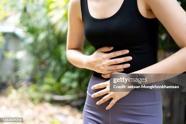 stomach ache woman - abdomen medical stock pictures, royalty-free photos & images