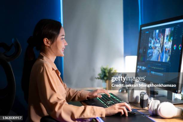 beautiful female video editor works with footage on her personal computer, she works in creative office studio. - video editing foto e immagini stock