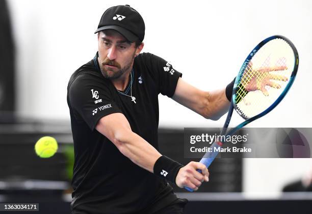 Steve Johnson of USA hits a backhand in his match against Karen Khachanov of Russia during day five of the 2022 Adelaide International at Memorial...