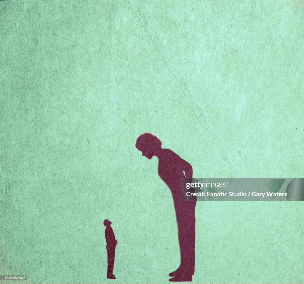 Concept image of a big woman leaning over a small man depicting dominance, aggression, woman boss, bully,