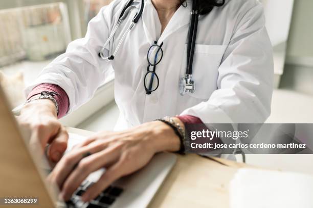 close-up of a female doctor using computer - female doctor on computer stock pictures, royalty-free photos & images