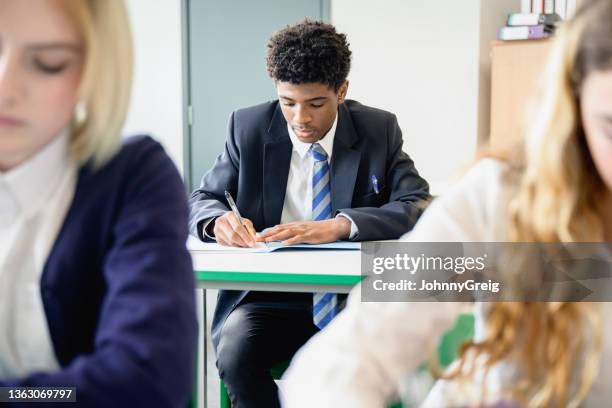 teenage students taking educational exam in classroom - blazer 個照片及圖片檔