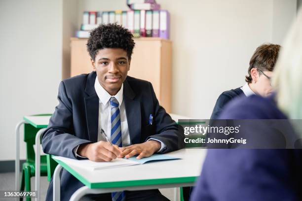 portrait of confident black secondary student taking exam - black blazer stock pictures, royalty-free photos & images