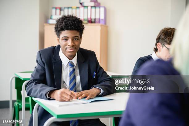 portrait of confident black secondary student taking exam - ssc exam stock pictures, royalty-free photos & images