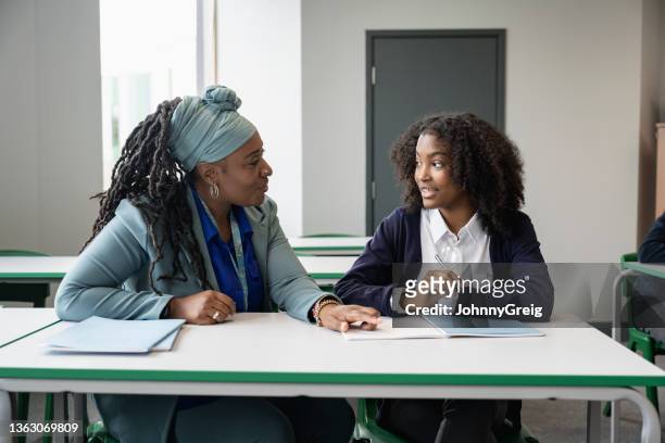 black educator working with multiracial student in classroom - teacher stock pictures, royalty-free photos & images