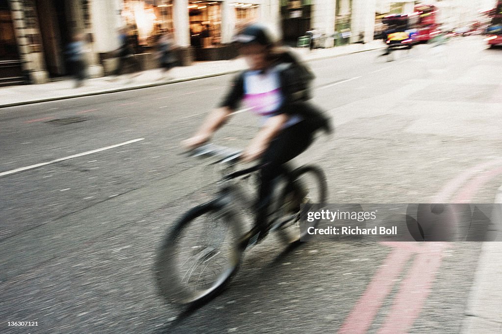 A blurred cyclist in London.