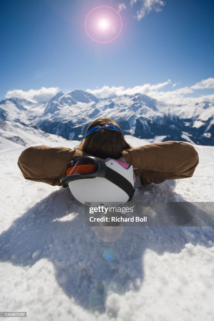 Girl sunbathing on the snow.