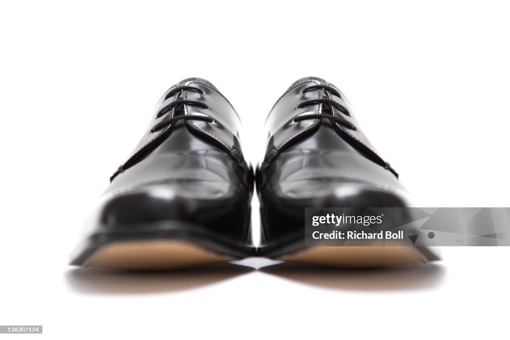 Black mens leather shoes viewed from the front.