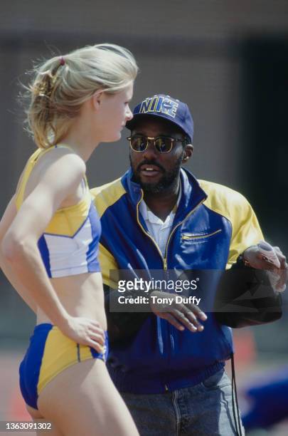 High Jumper Amy Acuff of the UCLA Bruins receives instructions from athletics coach Bob Kersee during the UCLA versus USC Track and Field meet on 6th...
