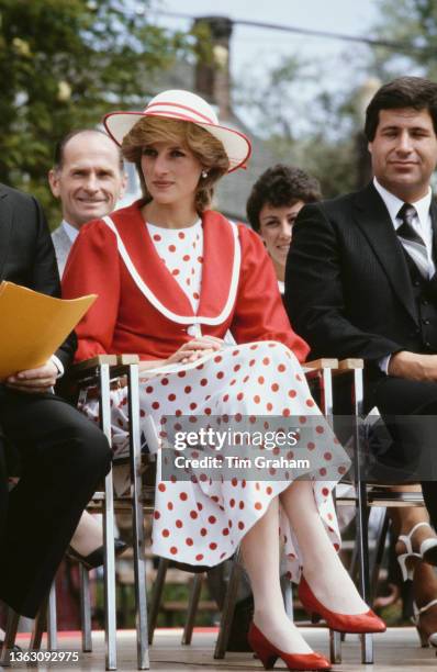 Diana, Princess of Wales wearing a red and white polka dot dress with a red jacket and a hat by John Boyd, whilst attending the Festival of Youth at...