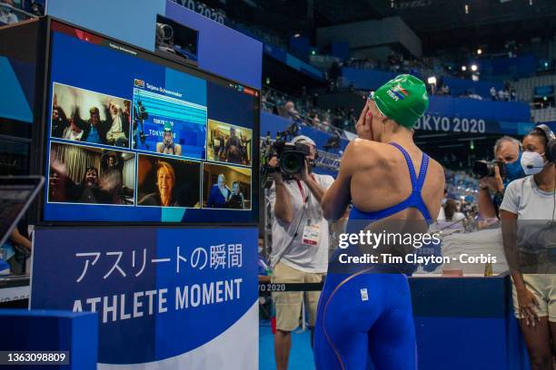 Silver medalist Tatjana Schoenmaker of South Africa talks to family on a poolside presentation as she leave the pool after the Women's 100m...