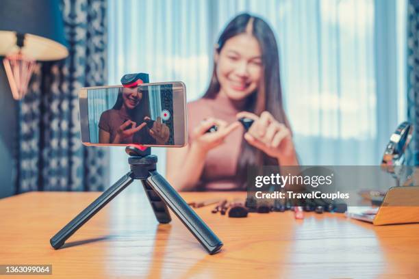 asian woman professional beauty vlogger or blogger live broadcasting cosmetic makeup tutorial viral video clip by camera sharing on social media. business online influencer on social media concept. online selling. online shopping - live event streaming stock pictures, royalty-free photos & images