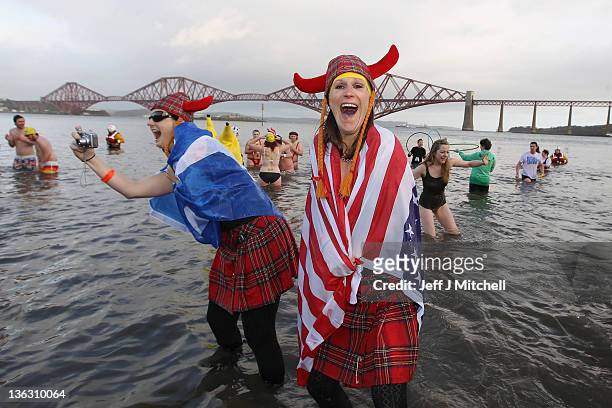 Over 1000 New Year revellers, many in fancy dress, braved freezing conditions in the River Forth in front of the Forth Rail Bridge during the annual...