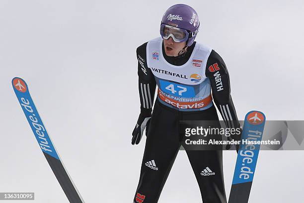 Martin Schmitt of Germany competes during the practice round of the FIS Ski Jumping World Cup event at the 60th Four Hills ski jumping tournament at...