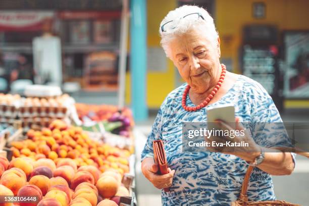 senior woman in the city - food street market stock pictures, royalty-free photos & images