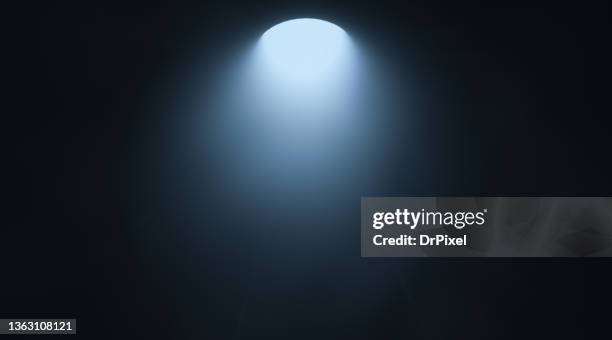 blue light in the dark room - spotlicht stockfoto's en -beelden