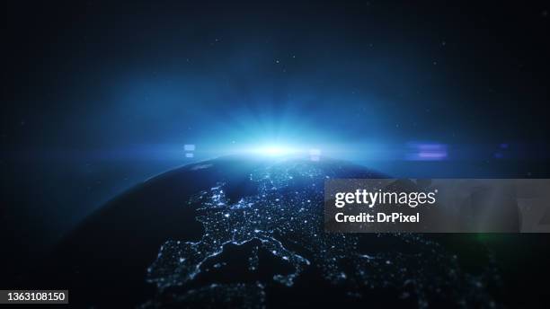 europe illuminated by cities lights in the night. rising sun and lens flare - north america from space stock pictures, royalty-free photos & images