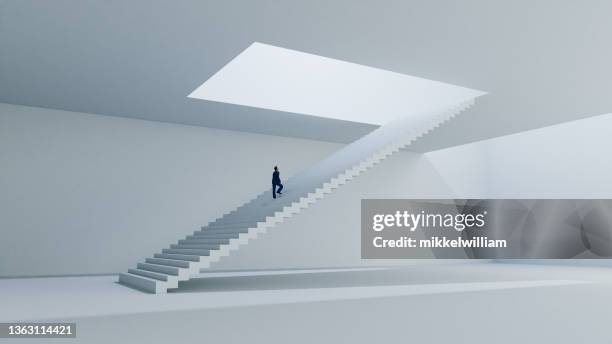 businessman walks on staircase towards the light - sayings stockfoto's en -beelden