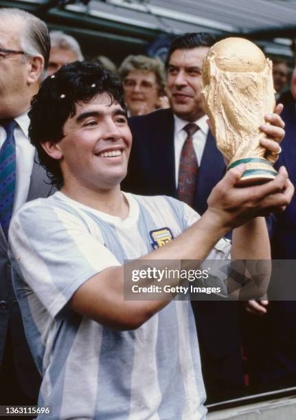 Argentina captain Diego Maradona holds aloft the trophy after the FIFA 1986 World Cup final match against West Germany at the Azteca Stadium on June...