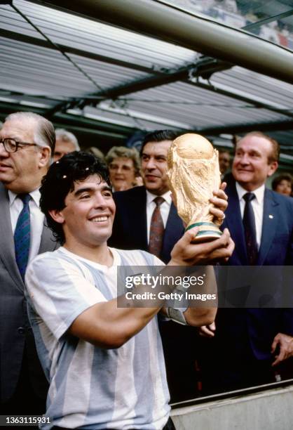 Argentina captain Diego Maradona holds aloft the trophy after the FIFA 1986 World Cup final match against West Germany at the Azteca Stadium on June...