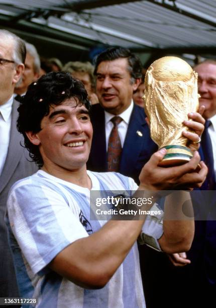 Argentina captain Diego Maradona holds aloft the trophy after the FIFA 1986 World Cup final match against West Germany at the Azteca Stadium on June...