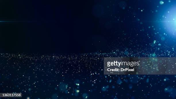 abstract defocused lights and particles - blue sparkle background photos et images de collection