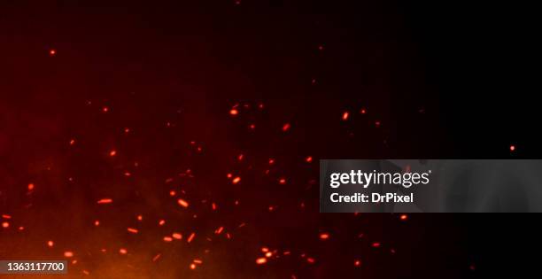 red hot sparks flying over the night sky - chispas fotografías e imágenes de stock