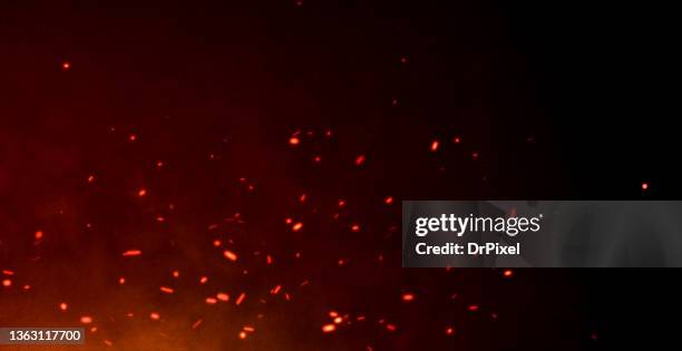 red hot sparks flying over the night sky - tizzone foto e immagini stock