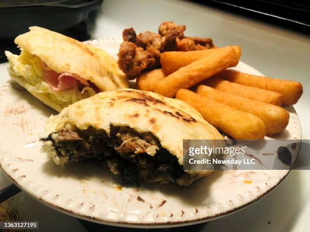 Photo of arepas, yucca fries and cochino frito on a plate at the Arepas Café, a new Venezuelan eatery in North Merrick, New York, on December 17,...