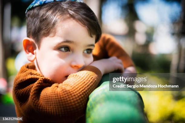 a young jewish boy looking away from the camera - jewish people stock-fotos und bilder