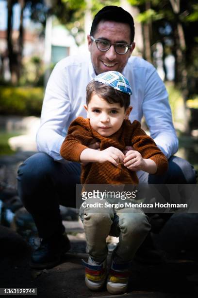 a young jewish man poses with his young son - jewish people ストックフォトと画像