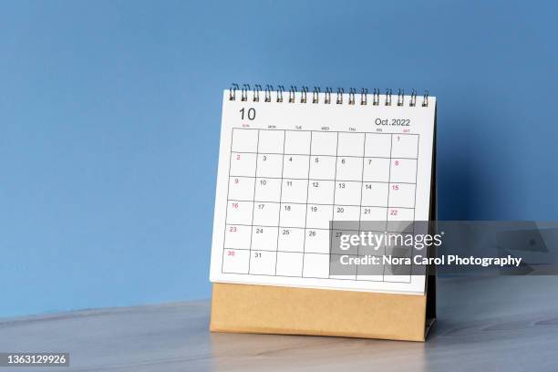 october 2022 desk calendar on blue background - outubro imagens e fotografias de stock