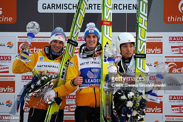 Andreas Kofler of Austria, Gregor Schlierenzauer of Austria and Dalki Ito of Japan pose on the podium after the FIS Ski Jumping World Cup event at...