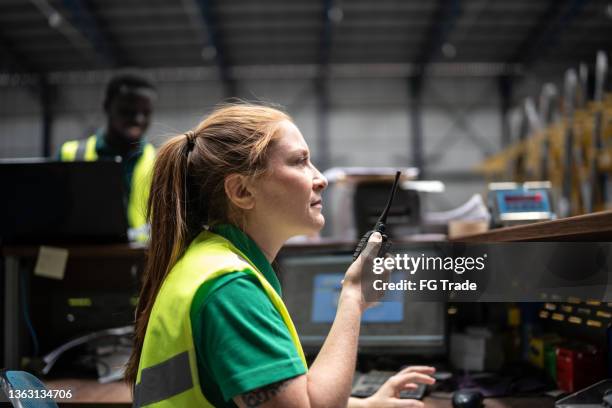 employee using radio communication at factory/industry - walkie talkie imagens e fotografias de stock