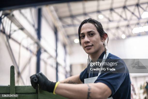portrait of a non-binary person working at a factory/industry - stereotypically working class stock pictures, royalty-free photos & images