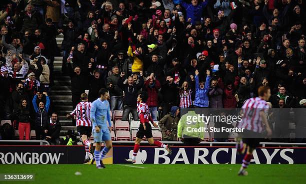 Sunderland goalscorer Ji Dong-Won celebrates his goal as the Sunderland fans get excited during the Barclays Premier League match between Sunderland...