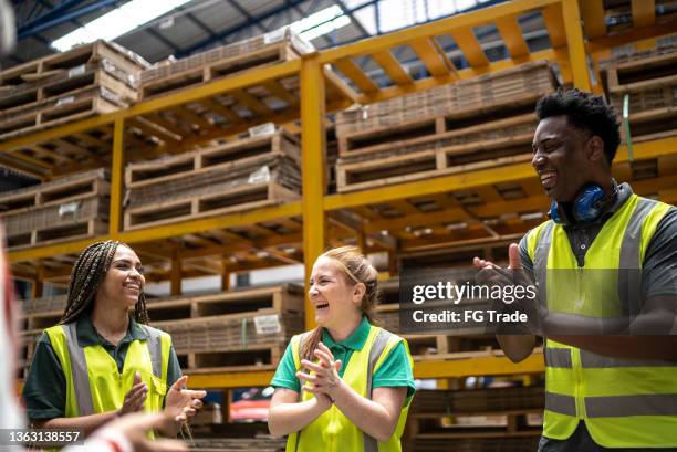 employees applauding during meeting in a factory - employee satisfaction stock pictures, royalty-free photos & images