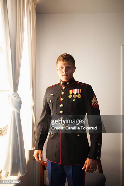 portrait of a young marine by the window - us marine corps stock pictures, royalty-free photos & images