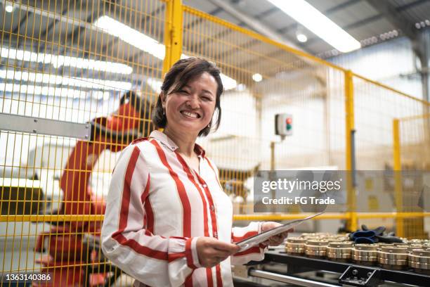 portrait of a mature woman working at a factory - executive producer stockfoto's en -beelden