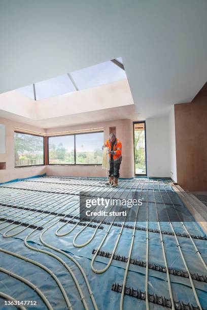 underfloor heating install - heating engineer stock pictures, royalty-free photos & images