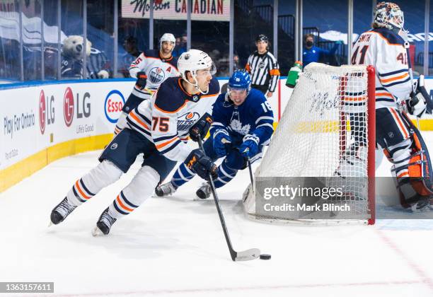 Evan Bouchard of the Edmonton Oilers skates against Mitchell Marner of the Toronto Maple Leafs during the third period at the Scotiabank Arena on...